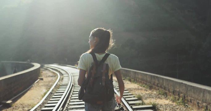 Girl walking on the railway