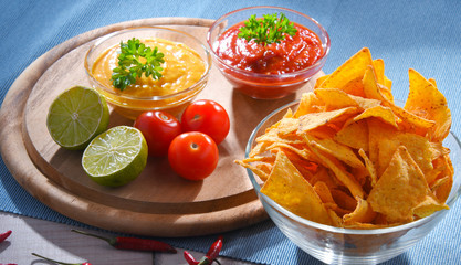 Composition with bowl of tortilla chips.