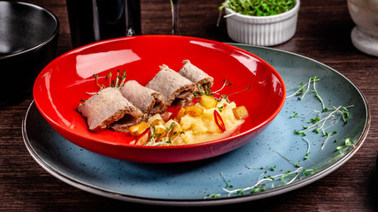 French cuisine concept. Baked duck fillet in beer, with pear and hot red pepper. Micro green peas. European serving dishes in the restaurant. copy space