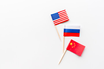 Creative top view flat lay of China, Russia and USA flags on white background in minimal style. 