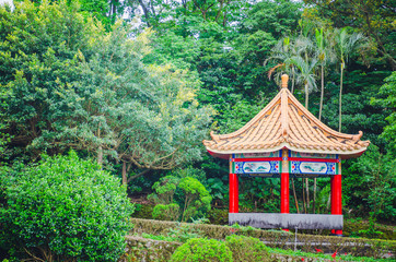 Chinese pavilion and temples at the Chinese Garden within a park with trees