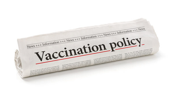 Rolled newspaper with the headline Vaccination policy