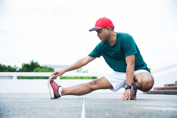 Young asian man stretching before exercise.
