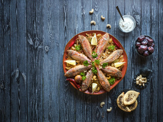 Arabian Fish Kabsa on a dark wooden background.