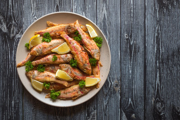 Dietary surmullet fish. Fried fish in a plate. 