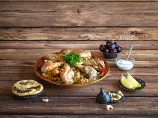 Homemade chicken Kabsa on a wooden background