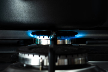Close up of a black pan sat on top of an open flame of a gas hob heating up the contents inside...