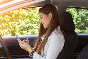 Beautiful attractive young woman smile in casual sitting in car using smartphone open GPS navigation app,Diving car with confident and happiness feeling,Happy transport concept