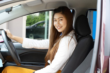 Beautiful attractive young woman smile in casual sitting in car,Diving car with confident and happiness feeling,Happy transport concept