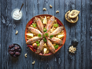 Arabian Fish Kabsa on a dark wooden background.