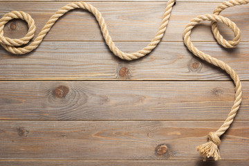 Obraz premium ship rope at wooden background texture
