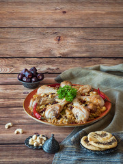 Homemade chicken Kabsa on a wooden background