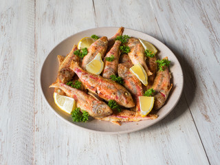 Dietary surmullet fish. Fried fish in a plate. 