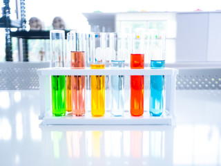 Colorful acid chemical tubes glassware example on white table for scientist experiment and research in laboratory