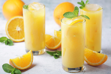 Glasses full of orange juice with ice