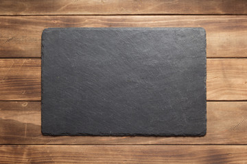 slate stone sign board at wooden plank