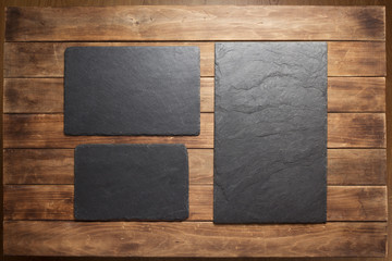 slate stone sign board at wooden plank