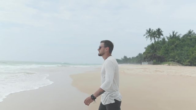Young man walking at beach