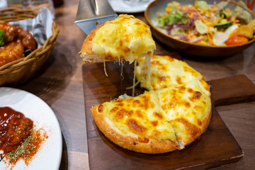 Pizza cheese on dinner table. Unhealthy from junk food.