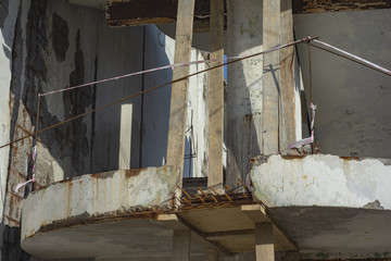 Old concrete outer staircase in the destroyed state in the process of repair