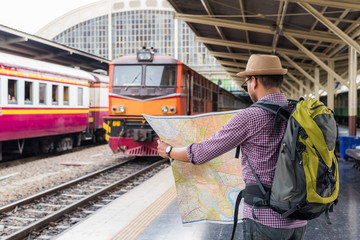 Young traveler man at platform train station. Traveling concept.