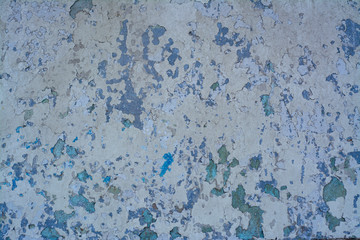 Old concrete wall with a complex texture of aged coating in shades of blue