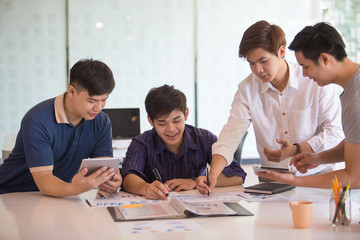 Business group or business partners discussing documents and ideas at meeting