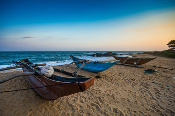 Fototapeta na wymiar Boats on a Tropical Beach, Kirinda, South Sri Lanka.