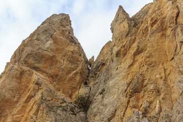 The collapse of stones from the cliff. Falling stones. Rockfall. The destruction of the rock.