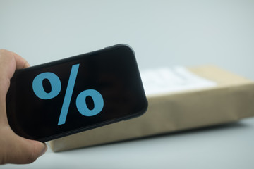 Smartphone with discount sign on screen in a shopping cart