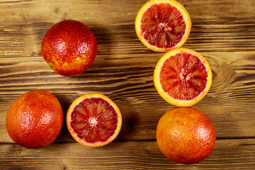 Red blood oranges on wooden table. Top view