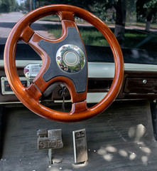 Large view of the steering wheel and electric car pedals.