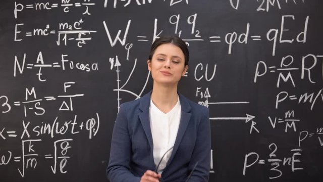 Seductive female teacher satisfied with proven theorem taking glasses off, flirt