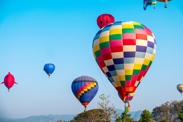 Colorful hot air balloon over mountain on blue sky - Image