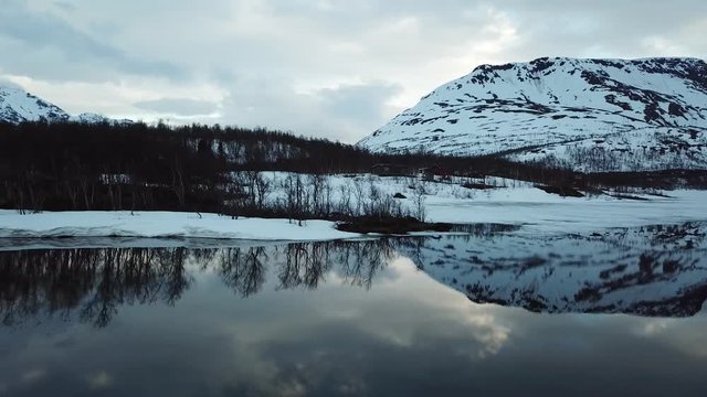 The mountains. Snow. Spring. Reflection in water.