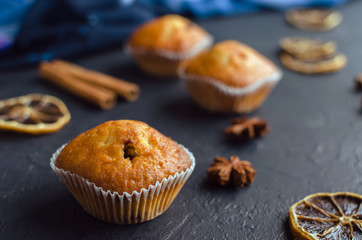 Sweet muffins with on dark textured background.