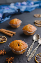 Sweet muffins with on dark textured background.