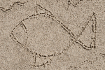 fish icon drawing on sand