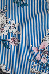 white fabric with blue stripes in big flowers