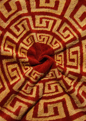 brown fabric with a circular spiral pattern