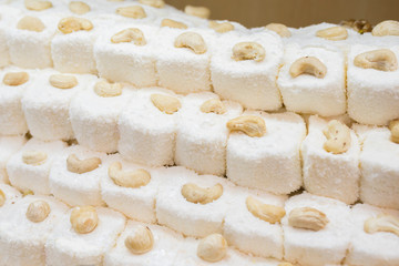 Turkish delight with nuts and coconut flakes. Traditional oriental sweets, natural products.