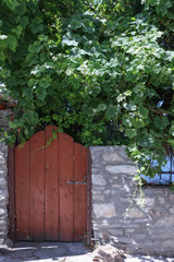 old wooden door in wall of stone