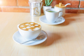 hot coffee on table / hot cappuccino with nice pattern milk foam 