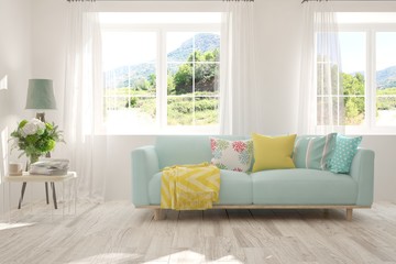 Stylish room in white color with sofa and summer landscape in window. Scandinavian interior design. 3D illustration