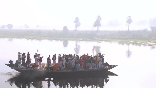 Hare Krishna pilgrims procession in a boat, Mayapur, India, 4k aerial 