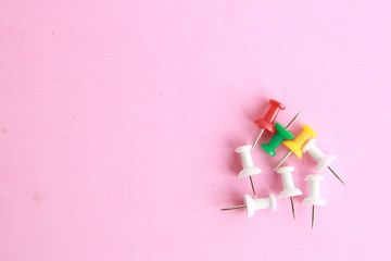 plastic thumbtacks in colorful background