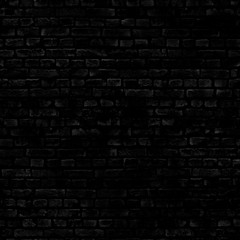 The damaged wall of the old house is made of black brick .Texture or background