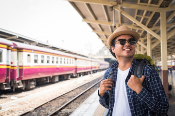 Young traveler man at platform train station. Traveling concept.