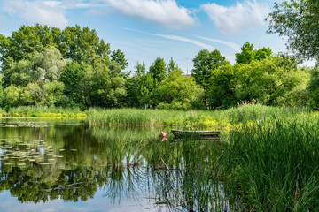 Lonely boat standing near the river Bank