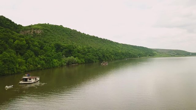Flying over the river on a sunny summer day. Dniester river of Moldova republic.